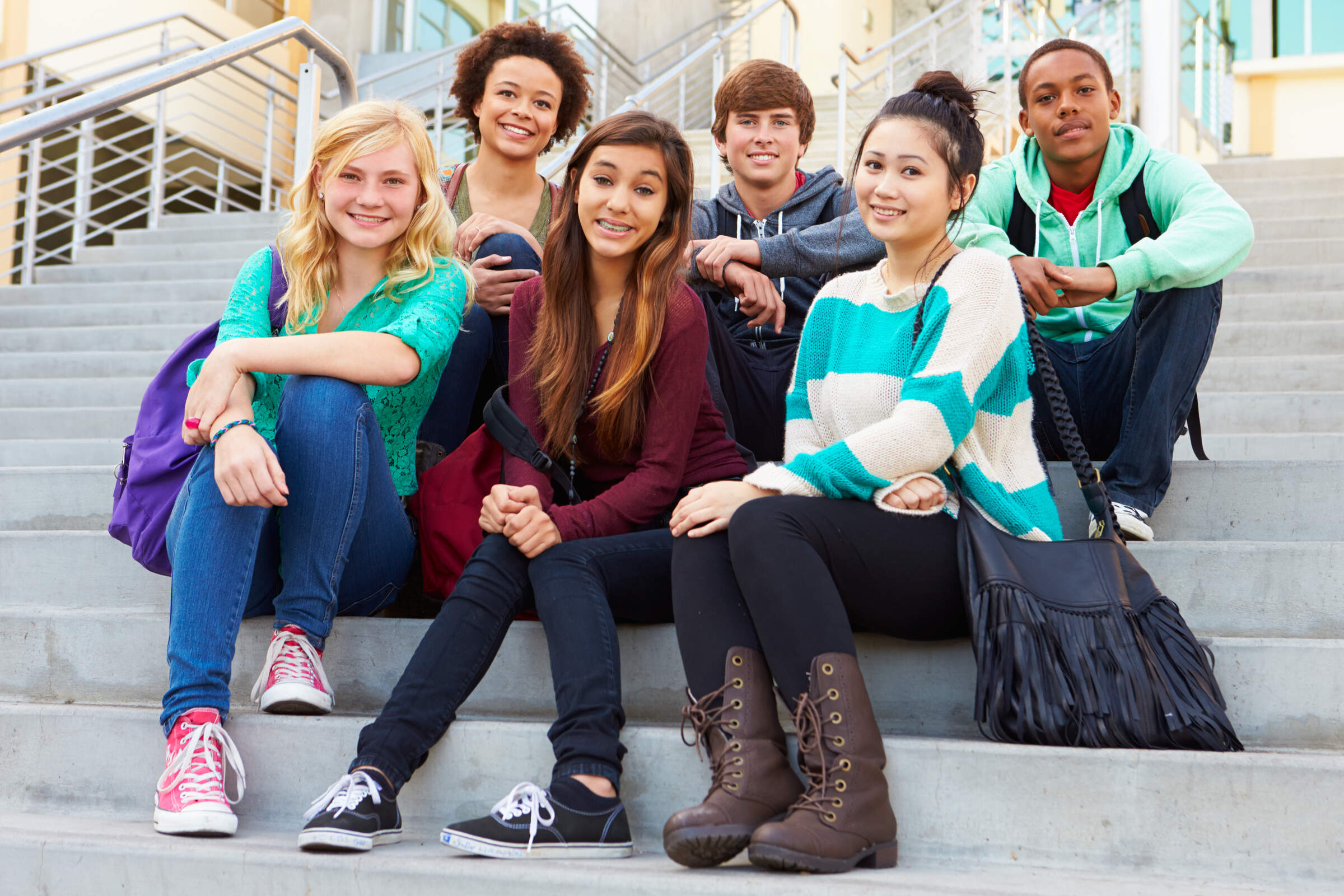 Portrait,Of,High,School,Students,Sitting,Outside,Building