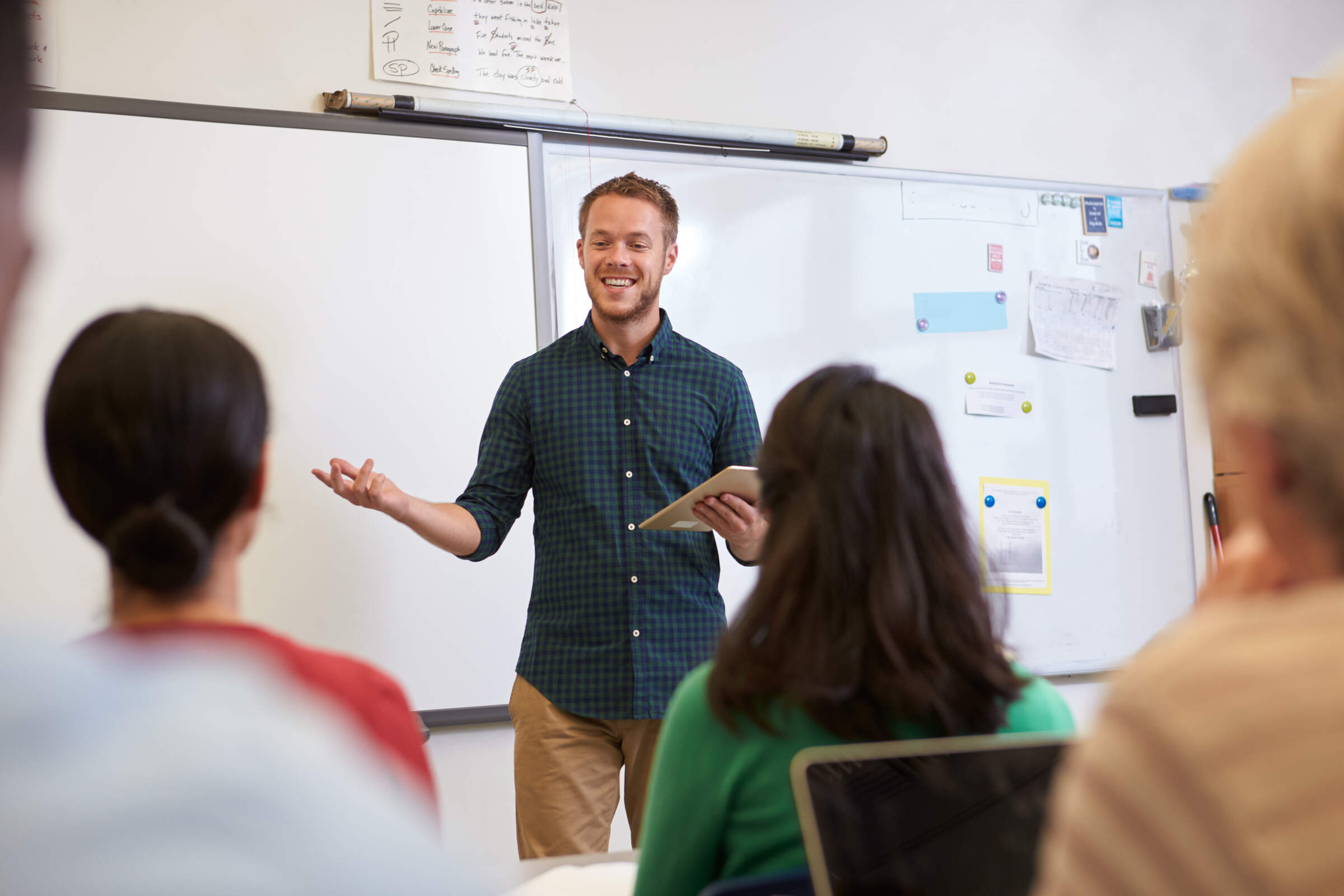 Male,Teacher,Listening,To,Students,At,Adult,Education,Class