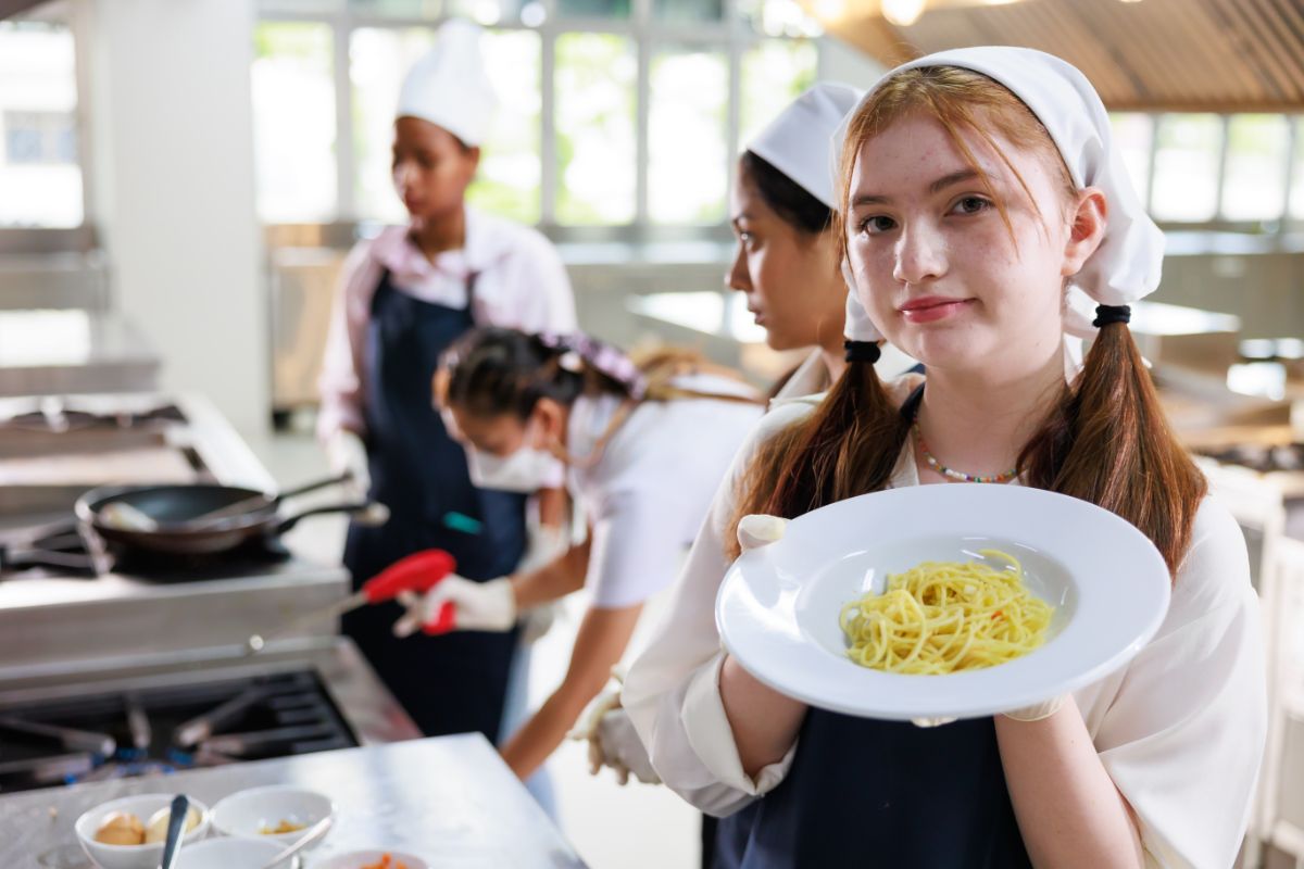 portrait-young-woman-cooking-student-cooking-class-culinary-classroom-happy-young-woman-multi-ethnic-students-are-focusing-cooking-lessons-cooking-school (1)